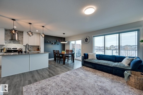 Living room with light wood-style floors and baseboards - 4 Caledon Crescent, Spruce Grove, AB - Indoor