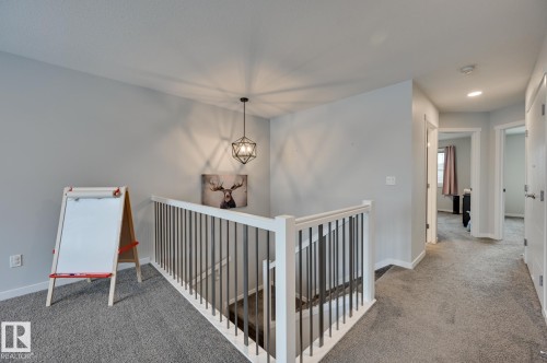 Hall with an upstairs landing, light carpet, and recessed lighting - 4 Caledon Crescent, Spruce Grove, AB - Indoor Photo Showing Other Room