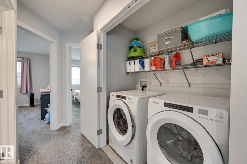 Laundry area featuring carpet floors and washer and dryer - 4 Caledon Crescent, Spruce Grove, AB - Indoor Photo Showing Laundry Room