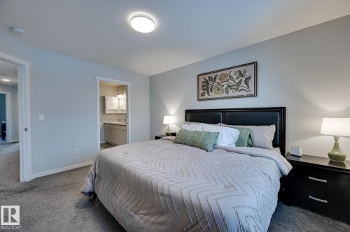 Carpeted bedroom featuring baseboards and connected bathroom - 4 Caledon Crescent, Spruce Grove, AB - Indoor Photo Showing Bedroom