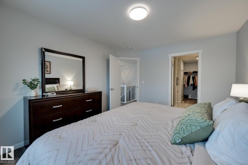 Bedroom featuring a spacious closet and dark carpet - 4 Caledon Crescent, Spruce Grove, AB - Indoor Photo Showing Bedroom