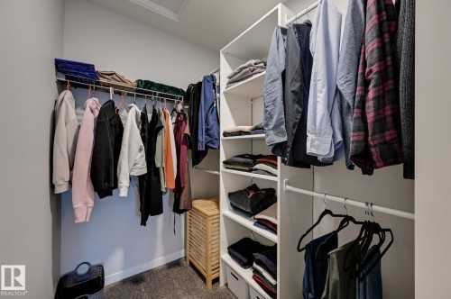 Walk in closet with dark carpet and attic access - 4 Caledon Crescent, Spruce Grove, AB - Indoor With Storage