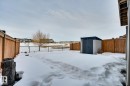 Yard layered in snow featuring a storage shed and a fenced backyard - 4 Caledon Crescent, Spruce Grove, AB  - Outdoor 