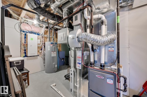 Utility room with heating unit, electric panel, and electric water heater - 4 Caledon Crescent, Spruce Grove, AB - Indoor Photo Showing Basement