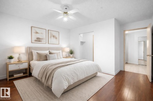 Bedroom featuring dark wood finished floors, ceiling fan, and a textured ceiling - 108 5065 31 Avenue, Edmonton, AB - Indoor Photo Showing Bedroom