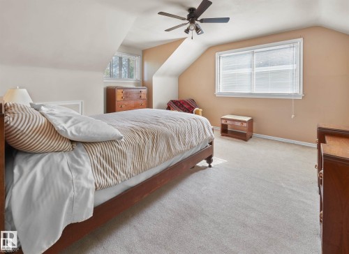 Bedroom with carpet flooring, lofted ceiling, and a ceiling fan - 11127 71 Avenue, Edmonton, AB - Indoor Photo Showing Bedroom