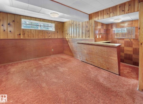 Bar with wood walls, carpet flooring, and wainscoting - 11127 71 Avenue, Edmonton, AB - Indoor Photo Showing Other Room