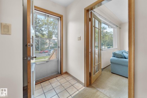 Doorway with carpet flooring and tile patterned floors - 11127 71 Avenue, Edmonton, AB - Indoor Photo Showing Other Room