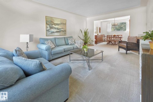 Living room featuring carpet floors and suspended lighting - 11127 71 Avenue, Edmonton, AB - Indoor Photo Showing Living Room