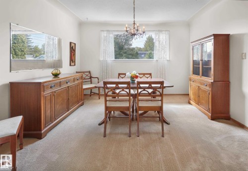 Dining area with light colored carpet and a chandelier - 11127 71 Avenue, Edmonton, AB - Indoor