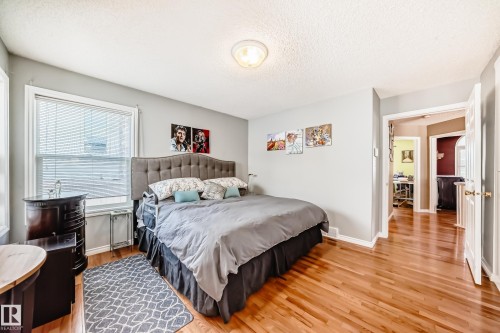 Bedroom with light wood-style flooring and a textured ceiling - 4 Harriott Court, St. Albert, AB - Indoor Photo Showing Bedroom