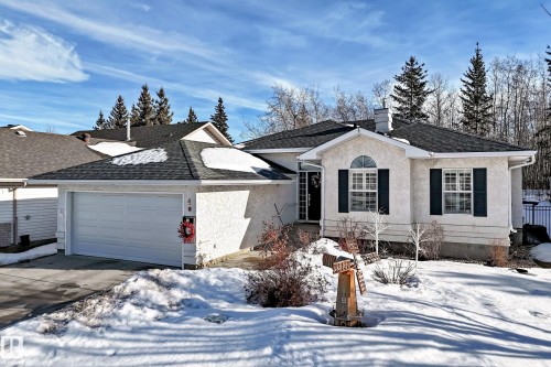 Single story home with stucco siding, a shingled roof, a chimney, driveway, and an attached garage - 4 Harriott Court, St. Albert, AB - Outdoor With Facade