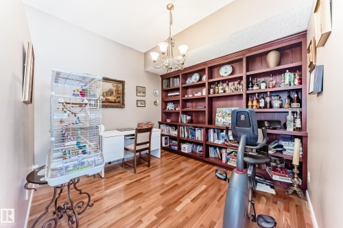 Home office with light wood-style floors and hanging lights - 4 Harriott Court, St. Albert, AB - Indoor