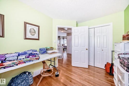 Office space with light wood-style floors and a textured ceiling - 4 Harriott Court, St. Albert, AB - Indoor Photo Showing Bedroom
