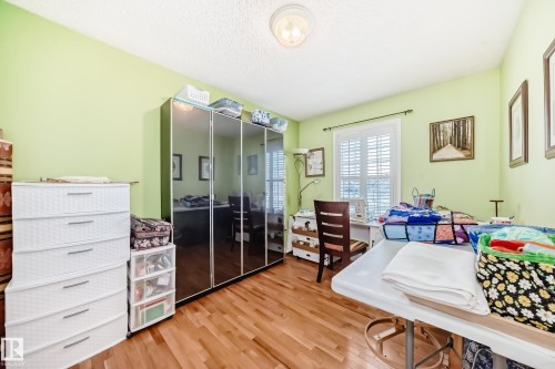 Bedroom with a closet, light wood finished floors, and a textured ceiling - 4 Harriott Court, St. Albert, AB - Indoor