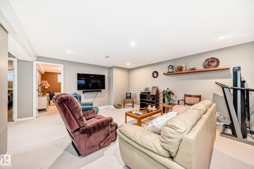 Carpeted living room featuring baseboards and recessed lighting - 4 Harriott Court, St. Albert, AB - Indoor With Fireplace