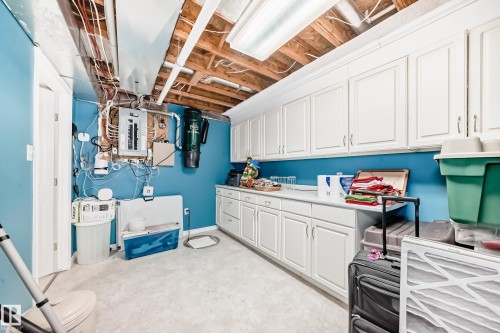 Laundry area featuring electric panel and unfinished concrete floors - 4 Harriott Court, St. Albert, AB - Indoor