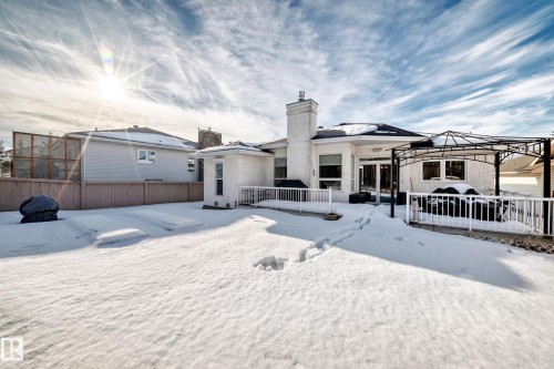 Snow covered rear of property featuring a wooden deck, a chimney, and a gazebo - 4 Harriott Court, St. Albert, AB - Outdoor