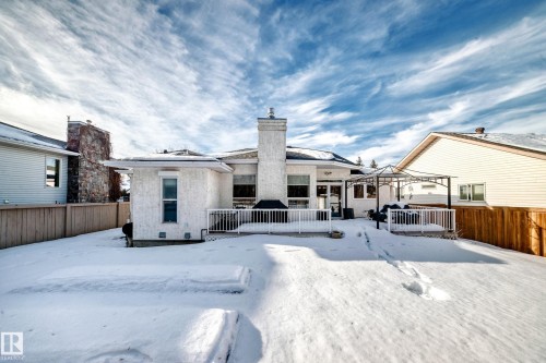 Snow covered house with a deck and a chimney - 4 Harriott Court, St. Albert, AB - Outdoor