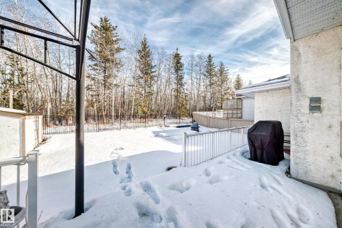 Yard covered in snow featuring a deck and a fenced backyard - 4 Harriott Court, St. Albert, AB - Outdoor