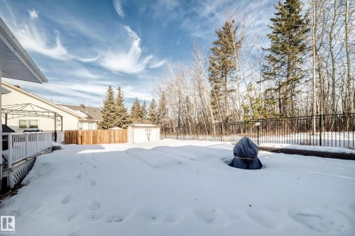 Yard layered in snow featuring a fenced backyard and a storage shed - 4 Harriott Court, St. Albert, AB - Outdoor