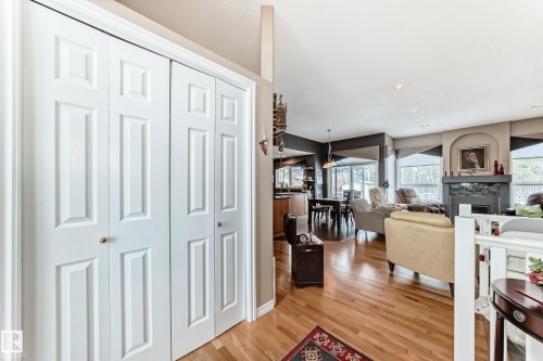 Corridor with light wood-type flooring and recessed lighting - 4 Harriott Court, St. Albert, AB - Indoor Photo Showing Other Room With Fireplace