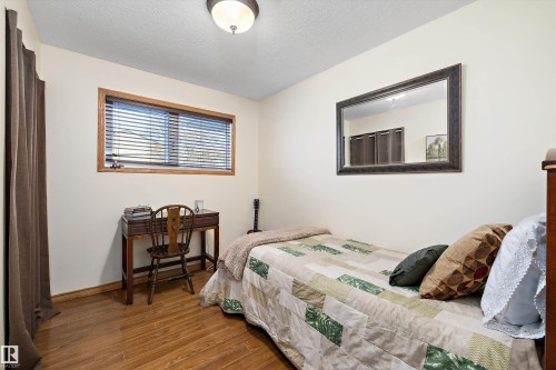 Bedroom with wood finished floors and a textured ceiling - 5703 143 Avenue, Edmonton, AB - Indoor Photo Showing Bedroom
