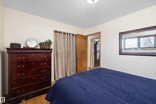 Bedroom featuring a textured ceiling and wood finished floors - 5703 143 Avenue, Edmonton, AB - Indoor Photo Showing Bedroom