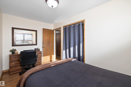 Bedroom featuring a textured ceiling and wood finished floors - 5703 143 Avenue, Edmonton, AB - Indoor Photo Showing Bedroom