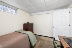 Bedroom with a drop ceiling and baseboards - 
