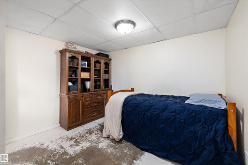 Bedroom with concrete floors and a paneled ceiling - 5703 143 Avenue, Edmonton, AB - Indoor Photo Showing Bedroom