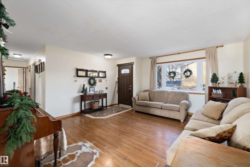 Living area with wood finished floors and a textured ceiling - 5703 143 Avenue, Edmonton, AB - Indoor Photo Showing Living Room