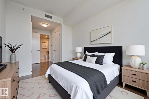 Bedroom with wood finished floors, connected bathroom, and a closet - 3901 10360 102 Street, Edmonton, AB - Indoor Photo Showing Bedroom