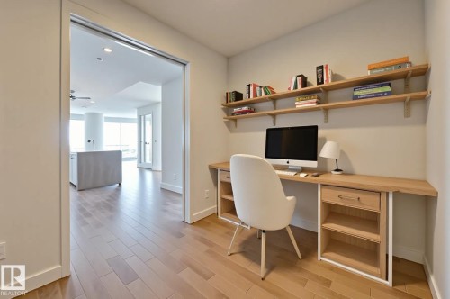 Office with built in study area, light wood finished floors, ceiling fan, and recessed lighting - 3901 10360 102 Street, Edmonton, AB - Indoor Photo Showing Office