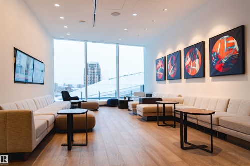 Community lobby featuring recessed lighting, expansive windows, and a city view - 3901 10360 102 Street, Edmonton, AB - Indoor Photo Showing Living Room