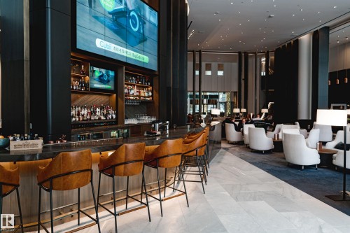 Community bar area with a towering ceiling and floor to ceiling windows - 3901 10360 102 Street, Edmonton, AB - Indoor Photo Showing Other Room