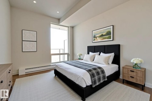 Bedroom featuring a baseboard heating unit, dark wood-style flooring, and recessed lighting - 3901 10360 102 Street, Edmonton, AB - Indoor Photo Showing Bedroom