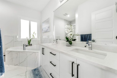 Full bath featuring a bath, a stall shower, and double vanity - 1522 17 Avenue, Edmonton, AB - Indoor Photo Showing Bathroom