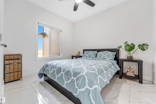 Bedroom featuring baseboards and a ceiling fan - 1522 17 Avenue, Edmonton, AB - Indoor Photo Showing Bedroom