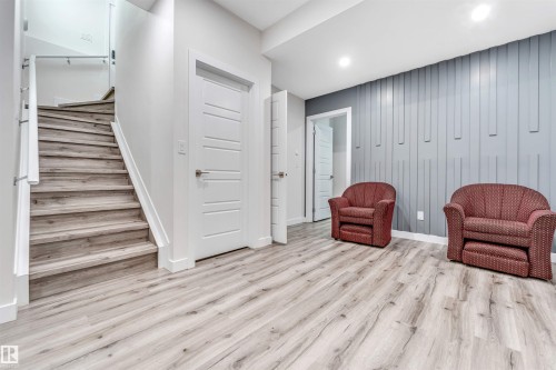 Living area with light wood-type flooring and stairs - 1522 17 Avenue, Edmonton, AB - Indoor Photo Showing Other Room