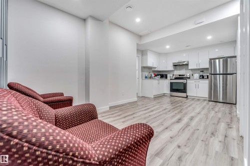 Living room featuring light wood-style floors and recessed lighting - 1522 17 Avenue, Edmonton, AB - Indoor Photo Showing Kitchen