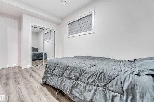 Bedroom with wood finished floors and a closet - 1522 17 Avenue, Edmonton, AB - Indoor Photo Showing Bedroom