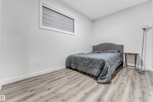 Bedroom with wood finished floors and baseboards - 1522 17 Avenue, Edmonton, AB - Indoor Photo Showing Bedroom