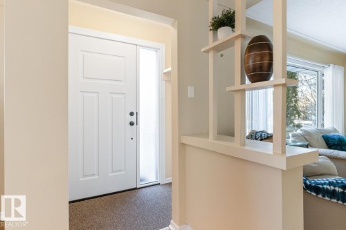 Front Entry Way featuring closet space and Mid Century Modern design touches - 8707 Strathearn Drive, Edmonton, AB - Indoor Photo Showing Other Room