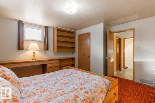 Basement Bedroom with built in desk and shelving - 8707 Strathearn Drive, Edmonton, AB - Indoor Photo Showing Bedroom