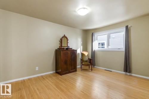Large Primary Bedroom with an impressive amount of Closet Space including built ins. - 8707 Strathearn Drive, Edmonton, AB - Indoor Photo Showing Other Room