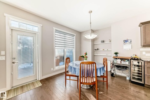 Dining room with beverage cooler and light wood-style floors - 7719 Getty Wynd, Edmonton, AB - Indoor Photo Showing Dining Room