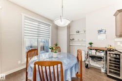 Dining area featuring beverage cooler and light wood-style floors - 