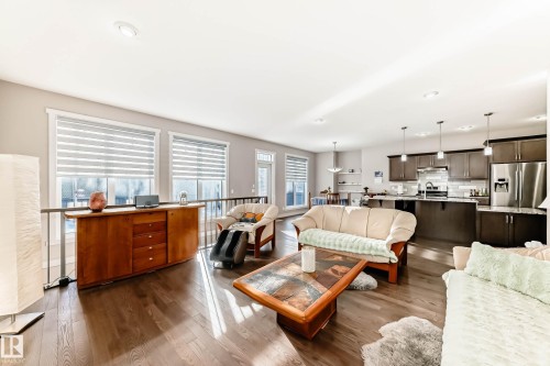 Living area featuring dark wood finished floors and recessed lighting - 7719 Getty Wynd, Edmonton, AB - Indoor Photo Showing Living Room