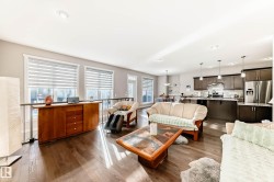 Living area featuring dark wood finished floors and recessed lighting - 